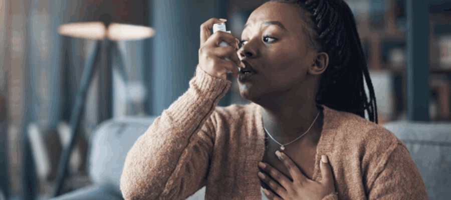 mulher jovem usando bombinha para asma alérgica